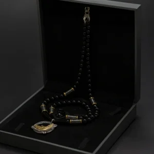 Black beaded necklace in open black box.