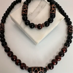 A stylish beaded necklace and bracelet set with black and brown patterns.
