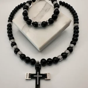 Black beaded necklace and bracelet set with a cross pendant.