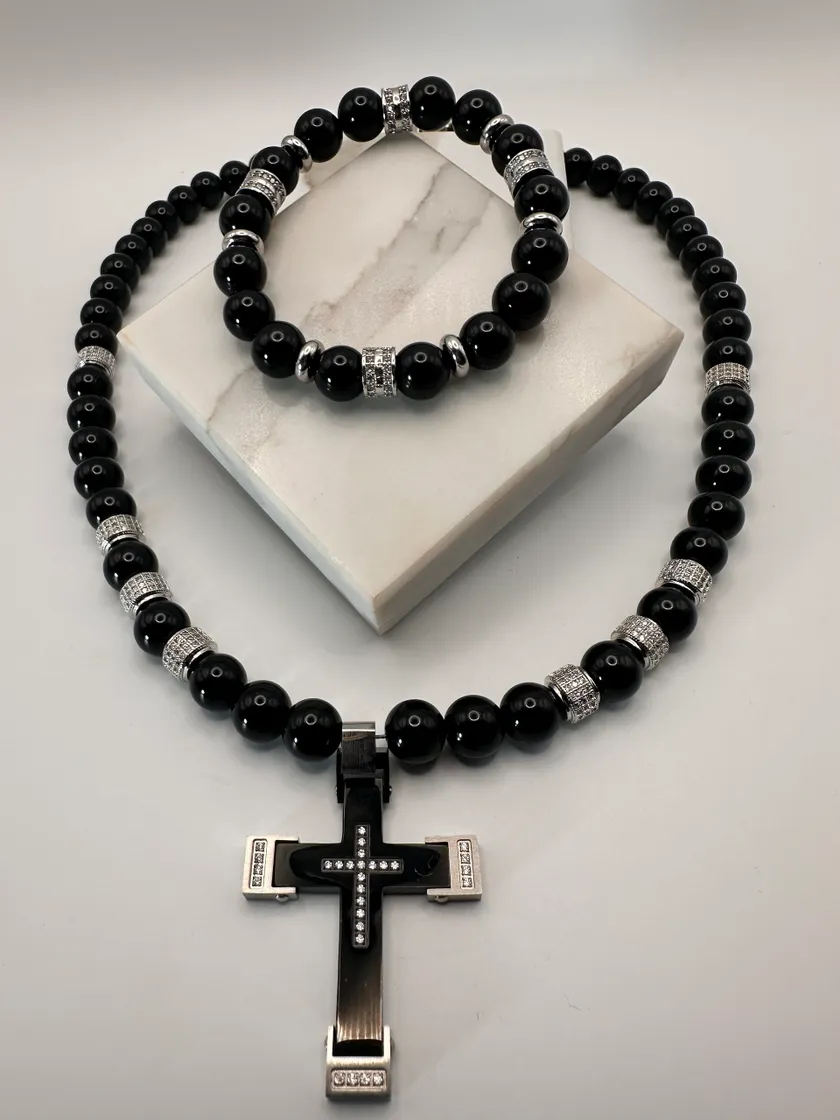 Black beaded necklace and bracelet set with a cross pendant.