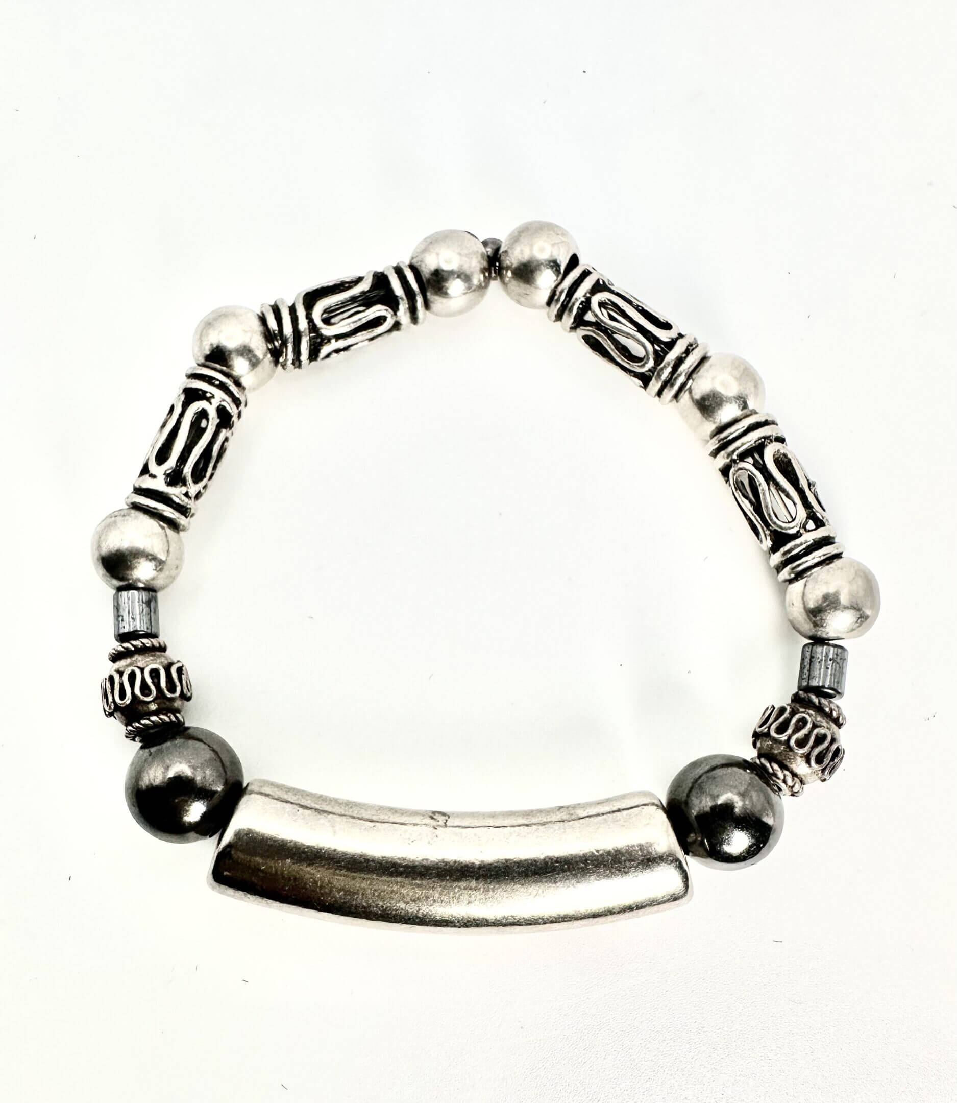 Silver and black beaded bracelet with a central curved bar.
