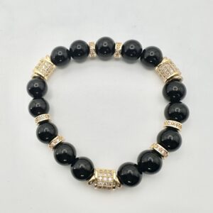 Elegant black beaded bracelet with gold accents and a central decorative bead.