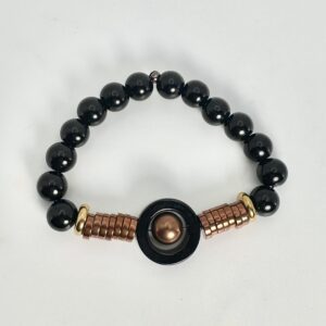 Black beaded bracelet with copper accents and a central circular charm.