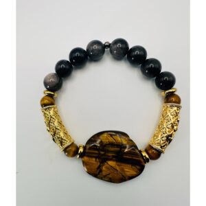 Elegant beaded bracelet with black and gold accents and a central tiger's eye stone.
