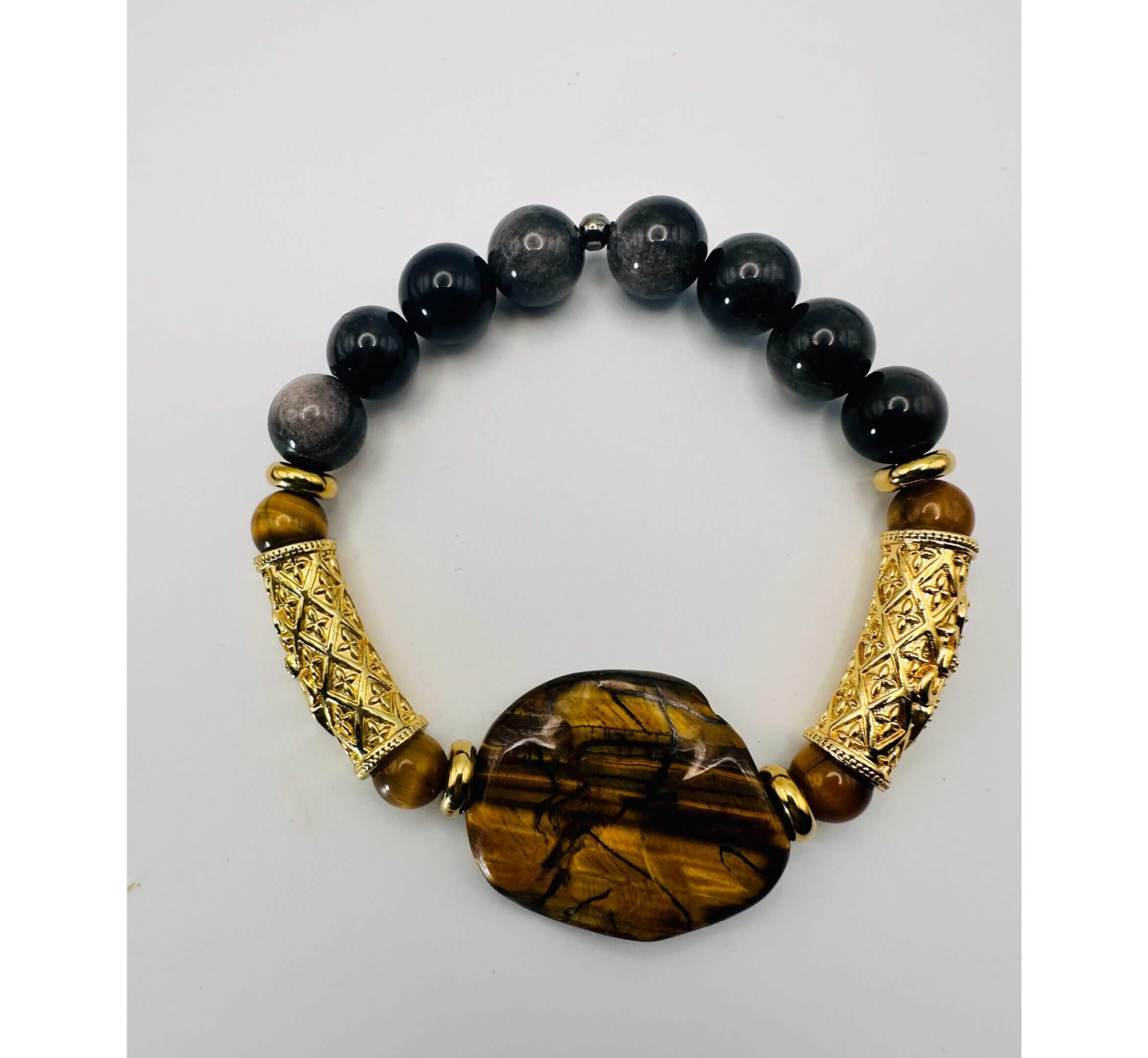 Elegant beaded bracelet with black and gold accents and a central tiger's eye stone.