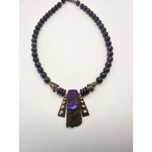 Beaded necklace with geometric pendant featuring blue accents.
