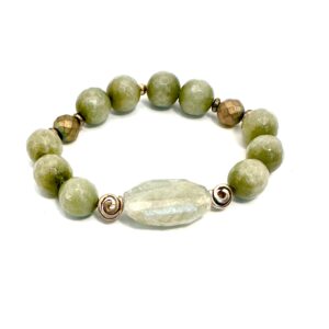 A beaded bracelet with green and translucent stones.