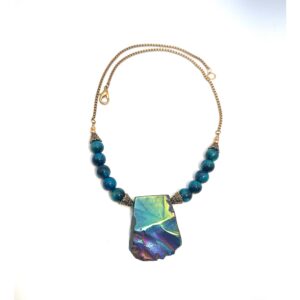 Colorful stone pendant necklace with blue beads on a gold chain.