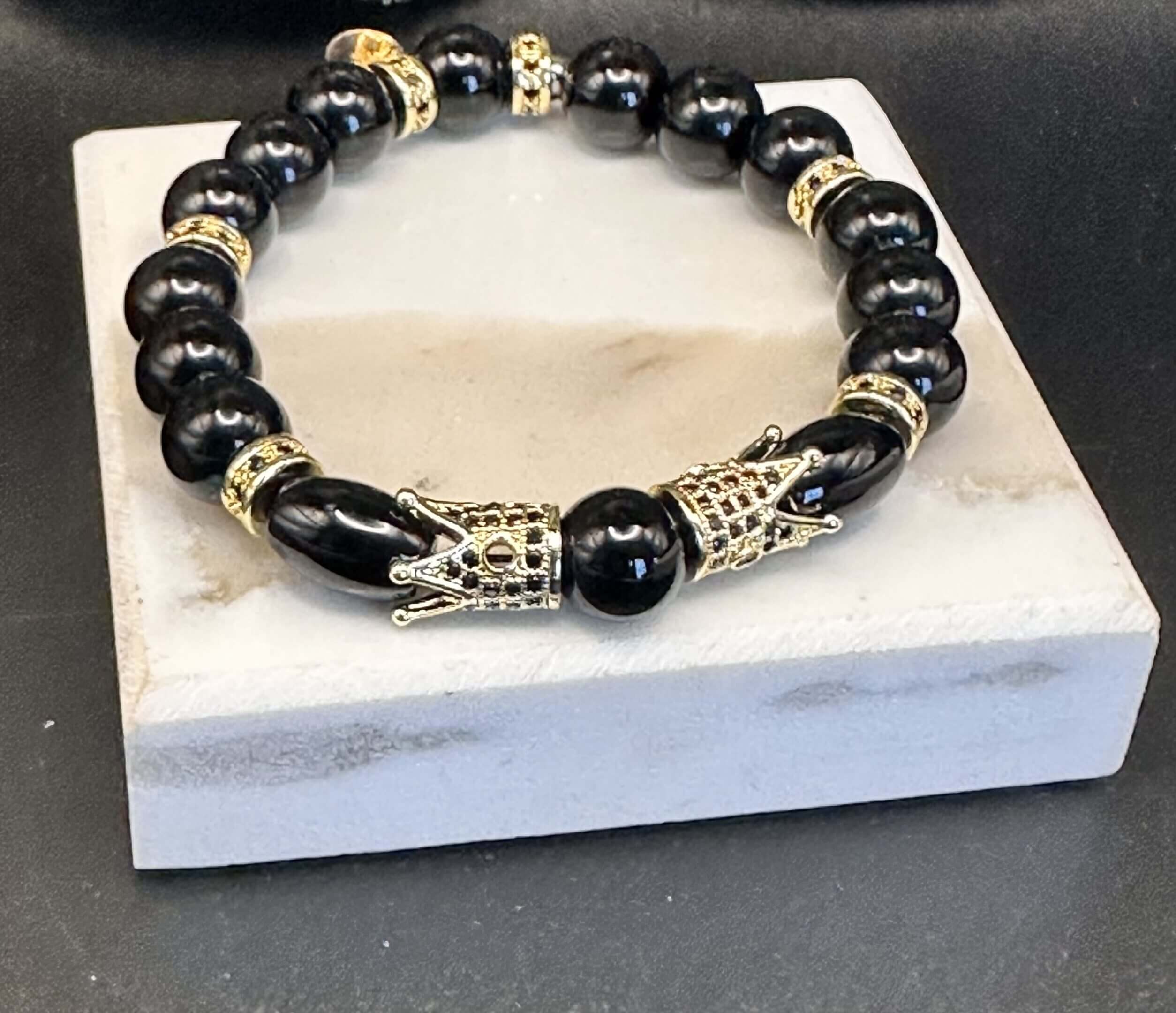 Black beaded bracelet with gold accents.
